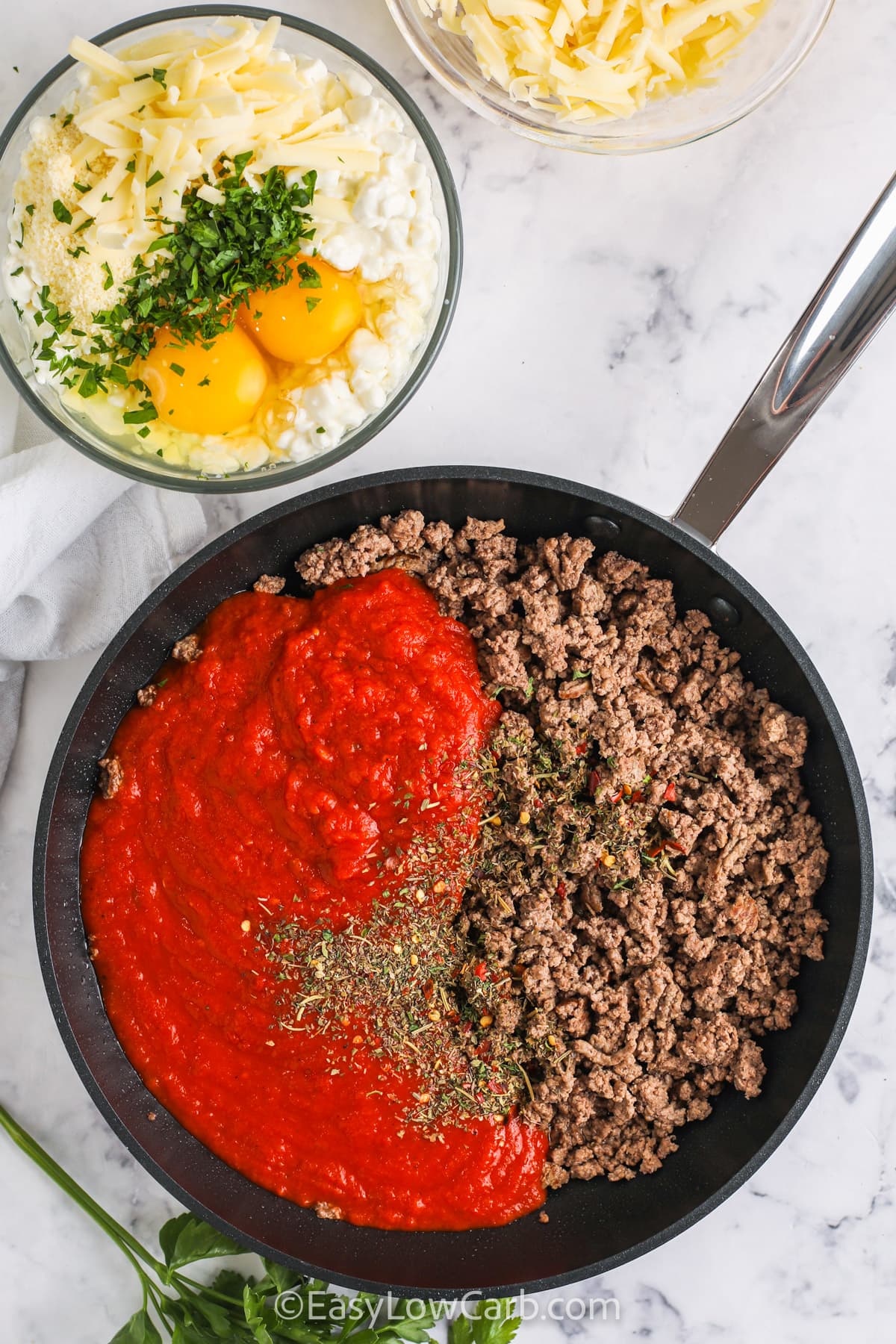 Make tonight simple with this low carb cabbage lasagna that the whole family can enjoy. Layers of tender cabbage, savory meat sauce, and cheesy filling come together for a hearty, satisfying meal without the extra carbs. It bakes up thick, holds its shape when sliced, and leftovers are perfect for quick dinners later. It also freezes well, making it a go-to for busy nights or meal prep. #easylowcarb adding ingredients to pan to make meat mixture for Cabbage Lasagna