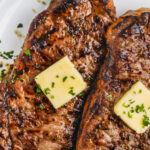close up of Grilled Striploin Steak on a plate with a title