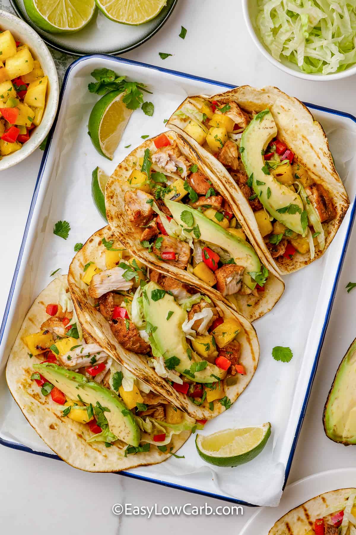 four grilled fish tacos on a plate