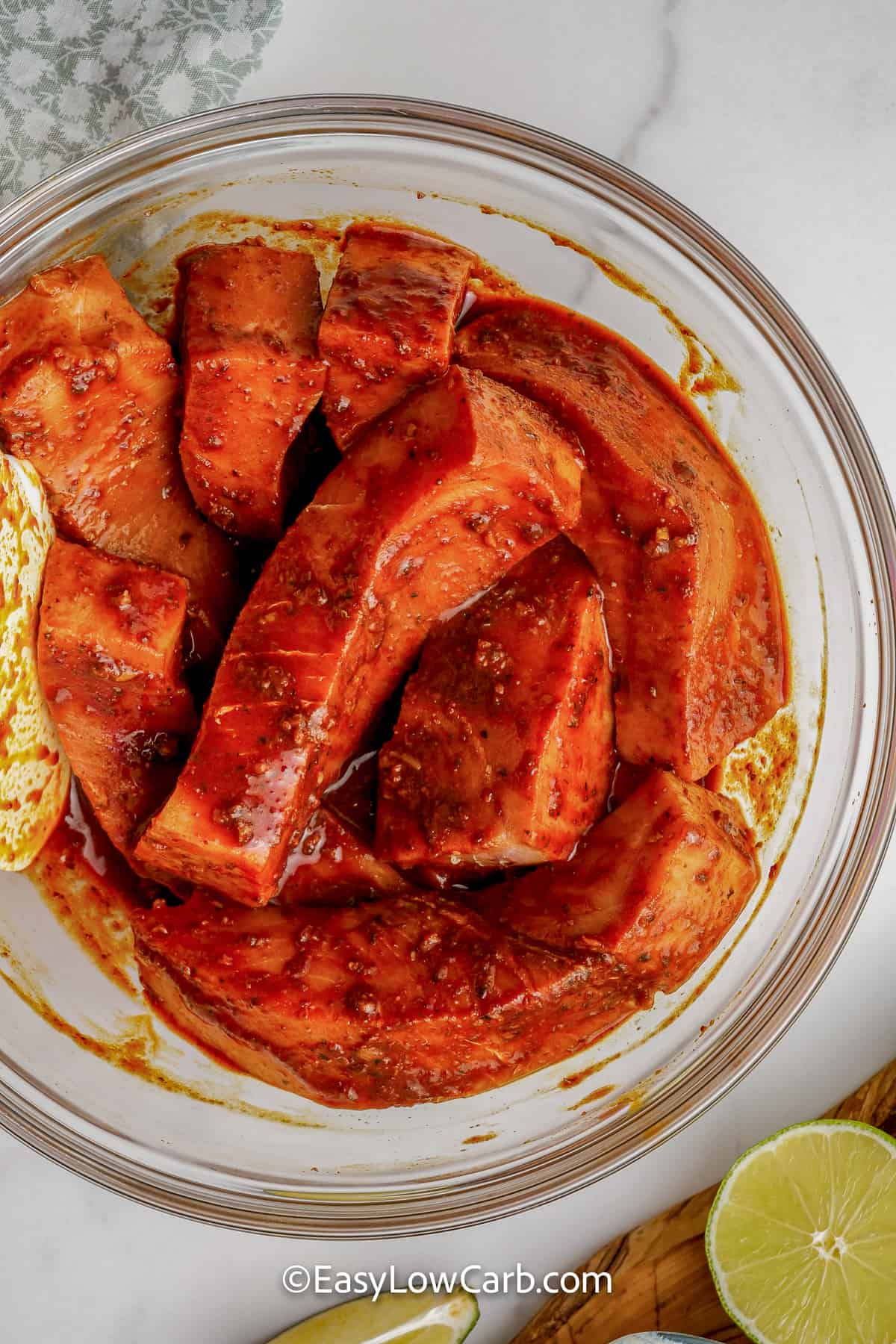 fish in a bowl with marinade, to make Grilled Fish Tacos
