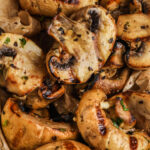 grilled mushrooms in a serving dish with a title