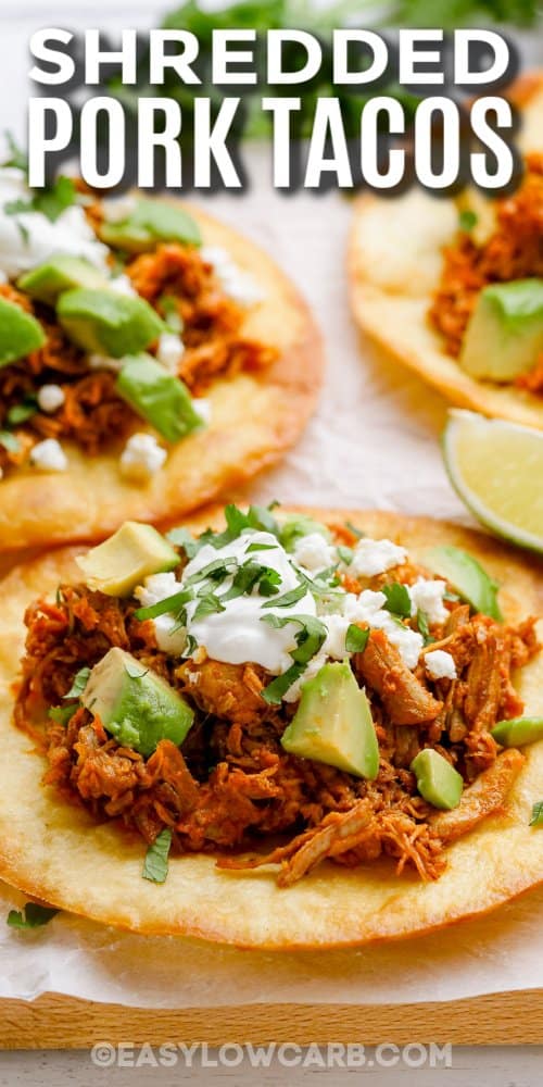 shredded pork tacos topped with avocado, sour cream, and cilantro, with text