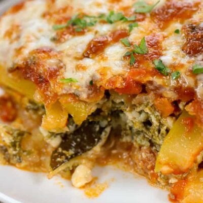 slice of low carb zucchini lasagna with piece missing
