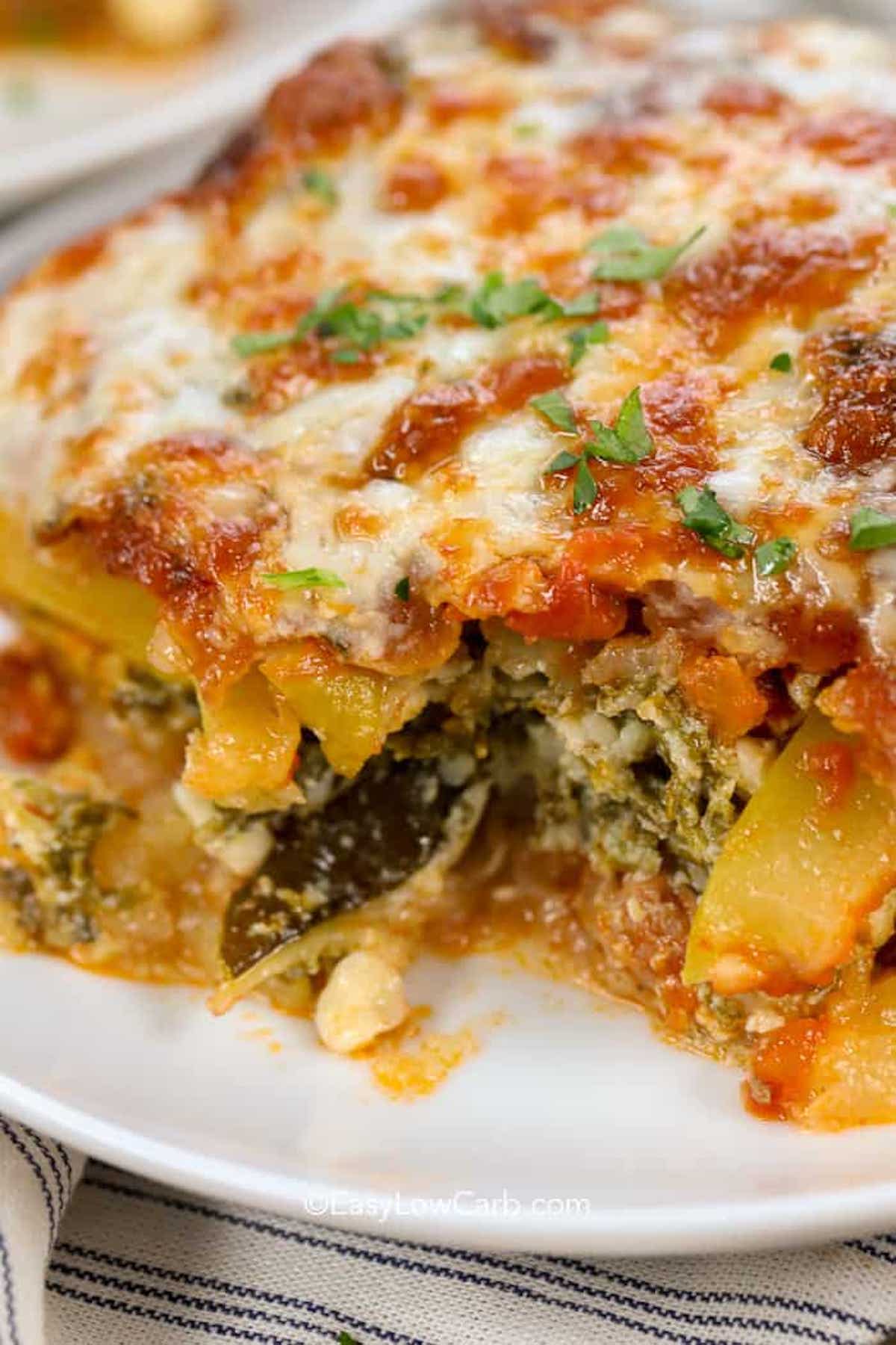 slice of low carb zucchini lasagna with piece missing