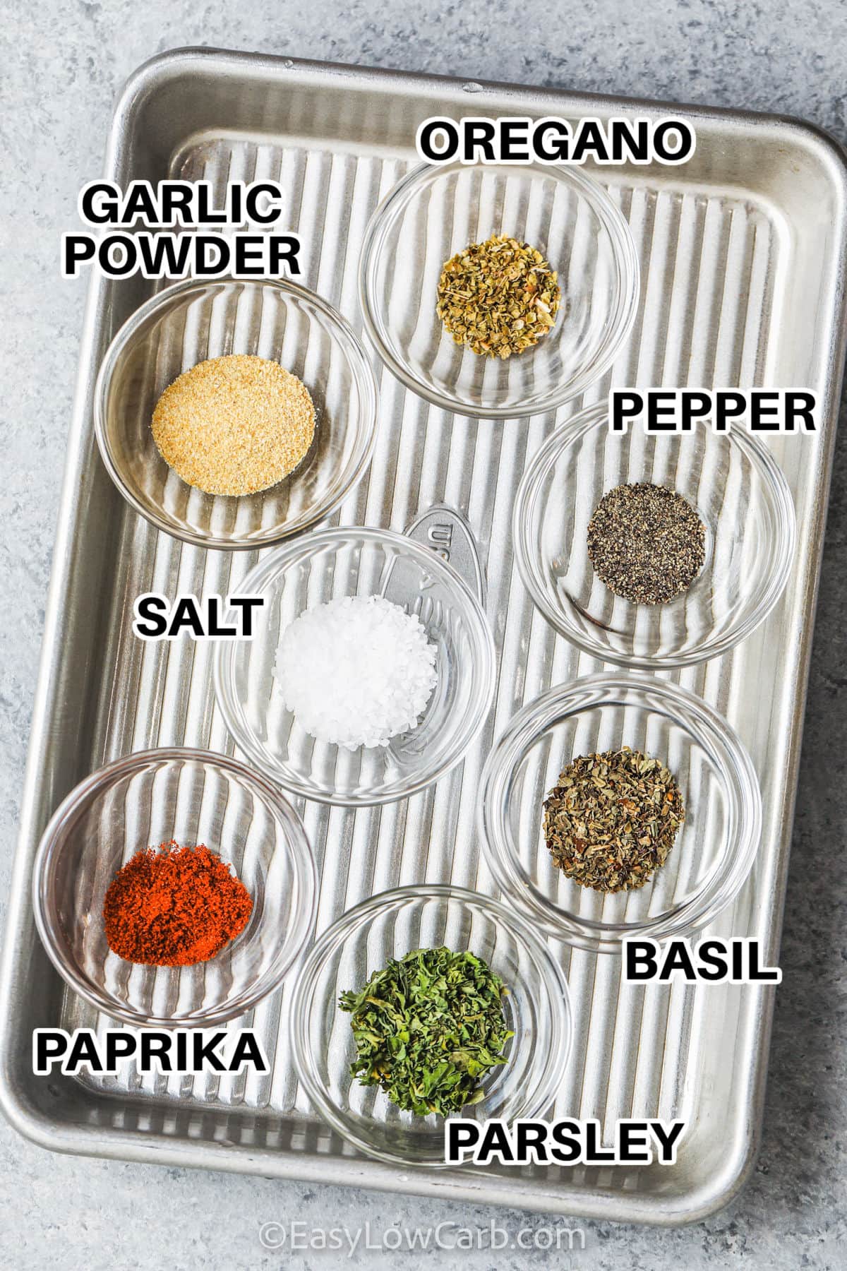 oregano , garlic powder , salt and pepper , basil , parsley and paprika to make Easy Garlic Herb Seasoning with labels