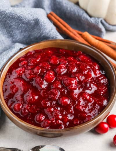 Keto Cranberry Sauce in a bowl with a spoon on the side
