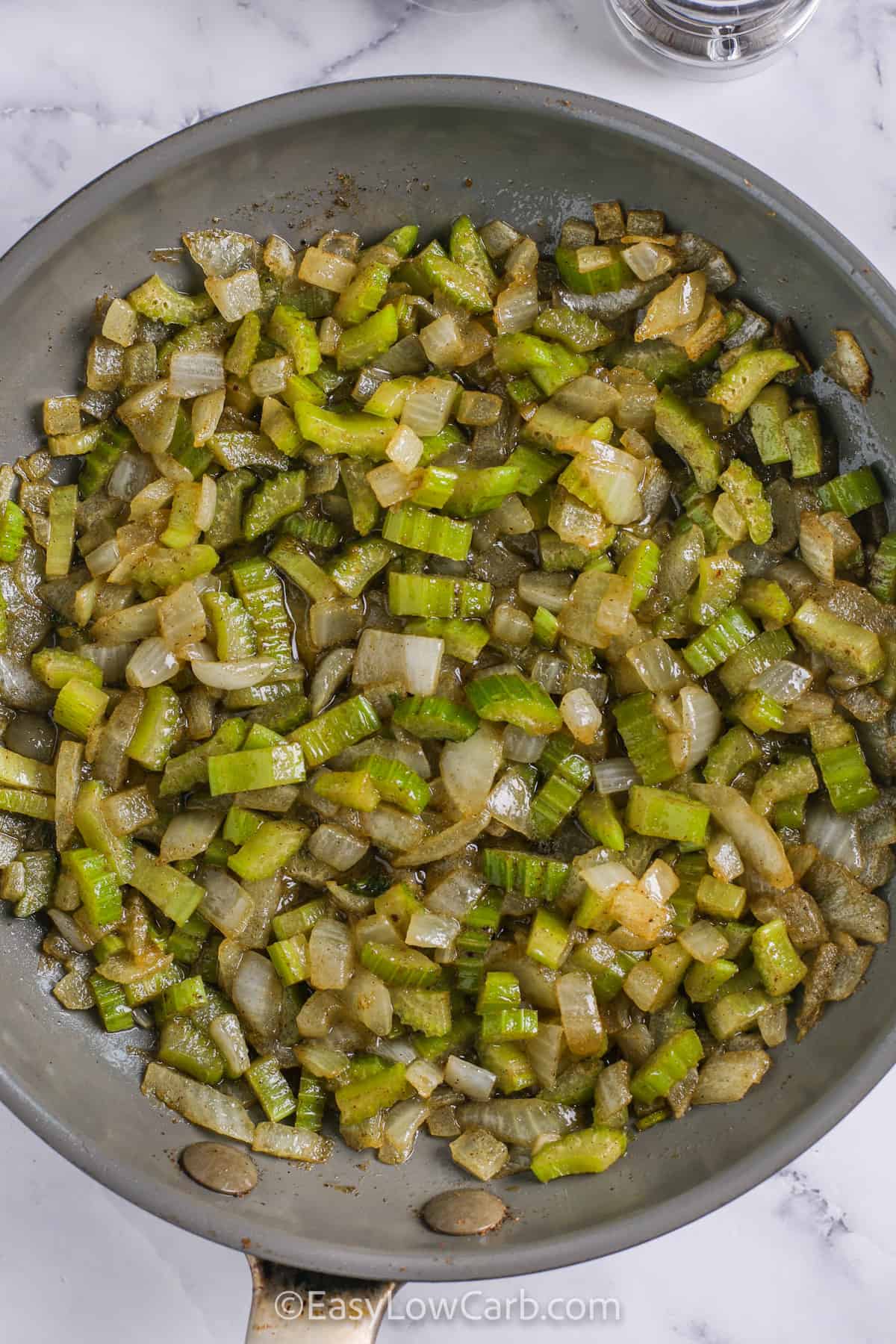 Keto stuffing takes buttery toasted bread cubes, sautéed onions, crisp celery, fresh herbs, and poultry seasoning, then adds chicken broth to keep it moist. Baked to a golden finish, it’s a hearty low carb side dish full of flavor. This simple recipe is easy to make ahead and perfect for holiday meals or Thanksgiving, providing all the comfort of classic stuffing without the extra carbs. #easylowcarb cooking vegetables to make Keto Stuffing