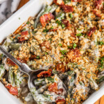 taking a spoonful of Keto Green Bean Casserole out of the dish