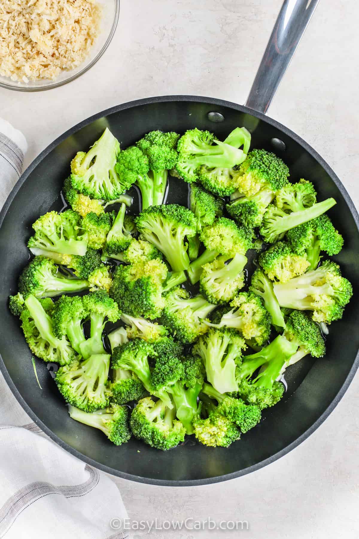 cooked broccoli in a pan to make Broccoli au Gratin