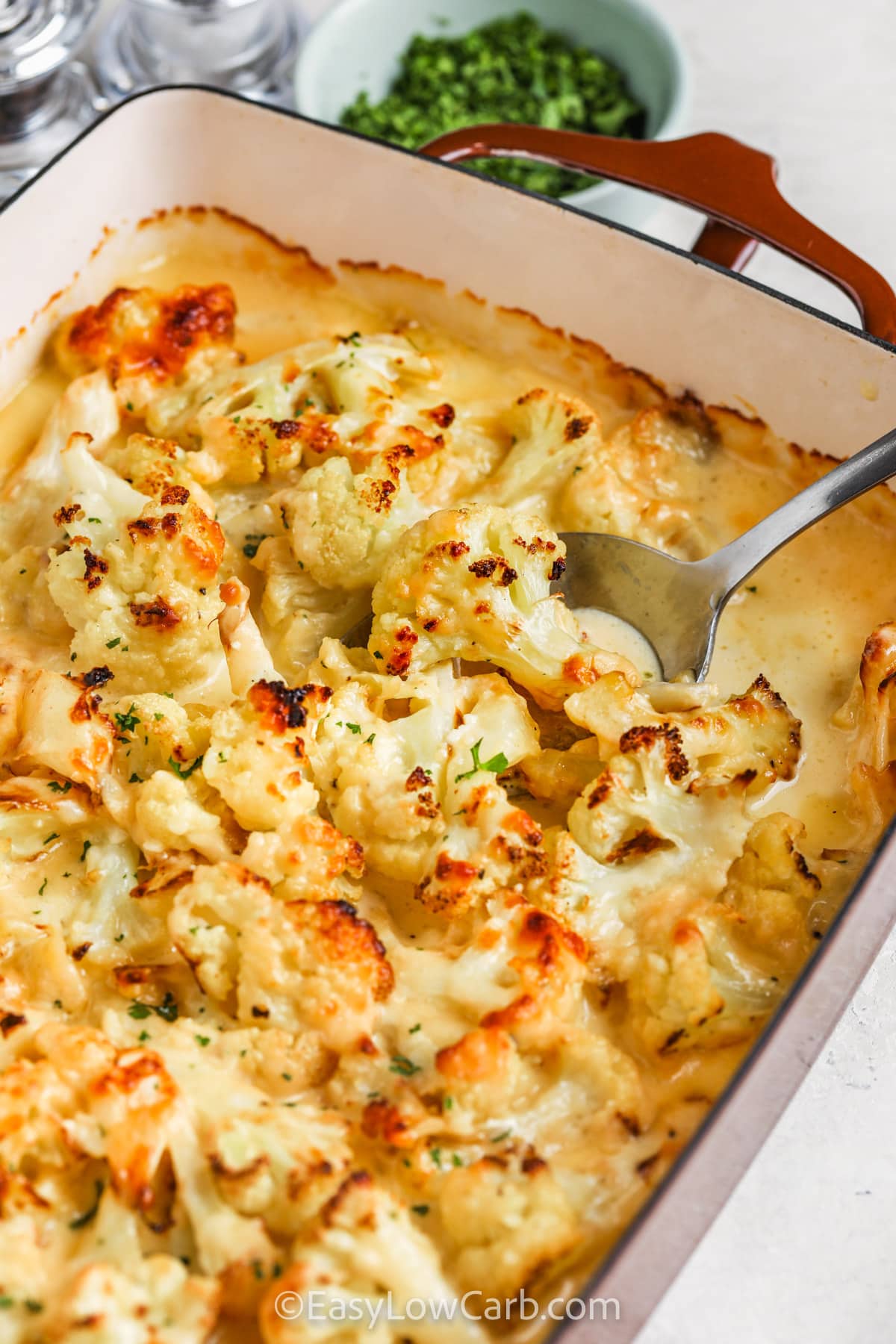 taking a spoonful of Cauliflower au Gratin