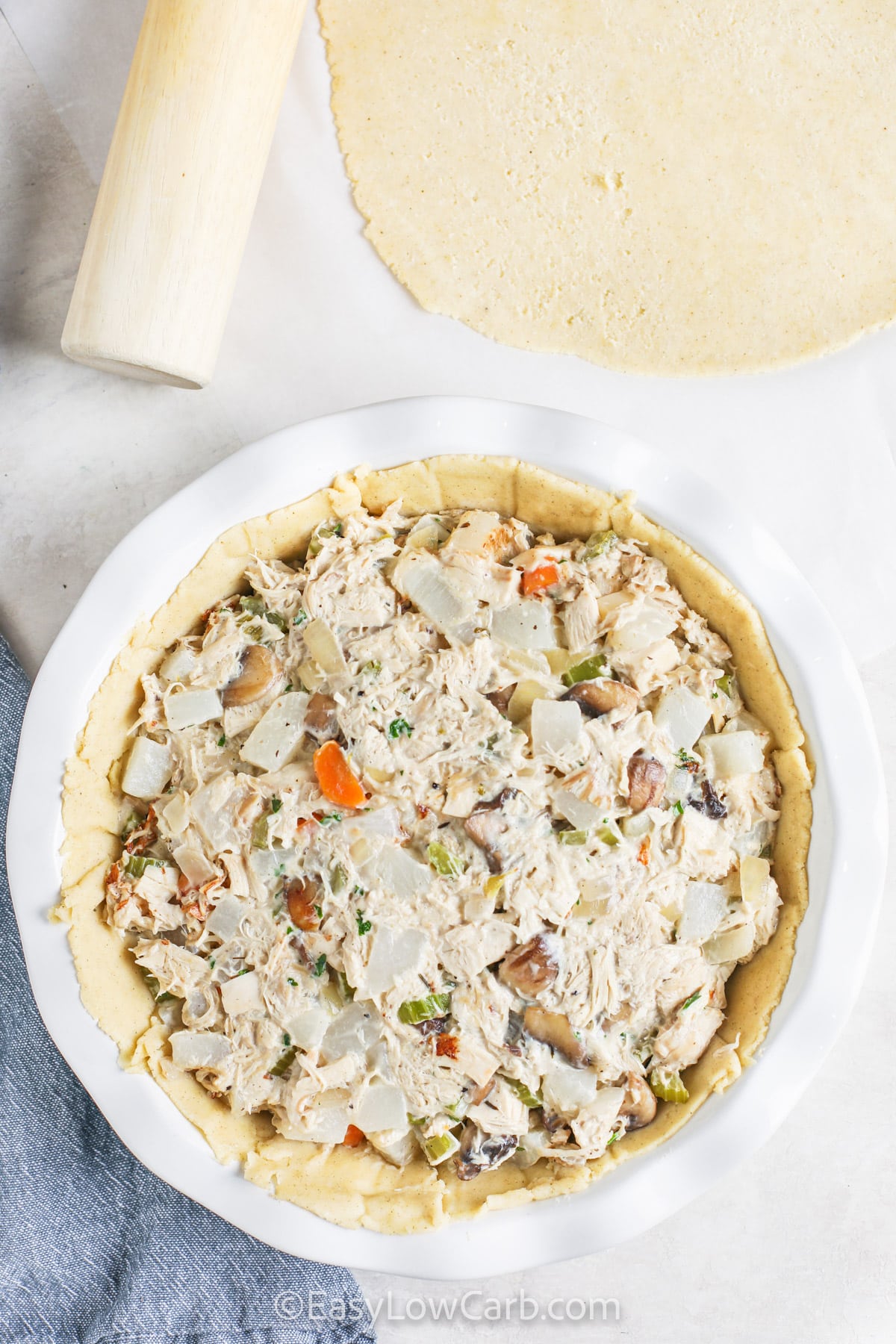 adding filling to pie crust to make Low Carb Chicken Pot Pie