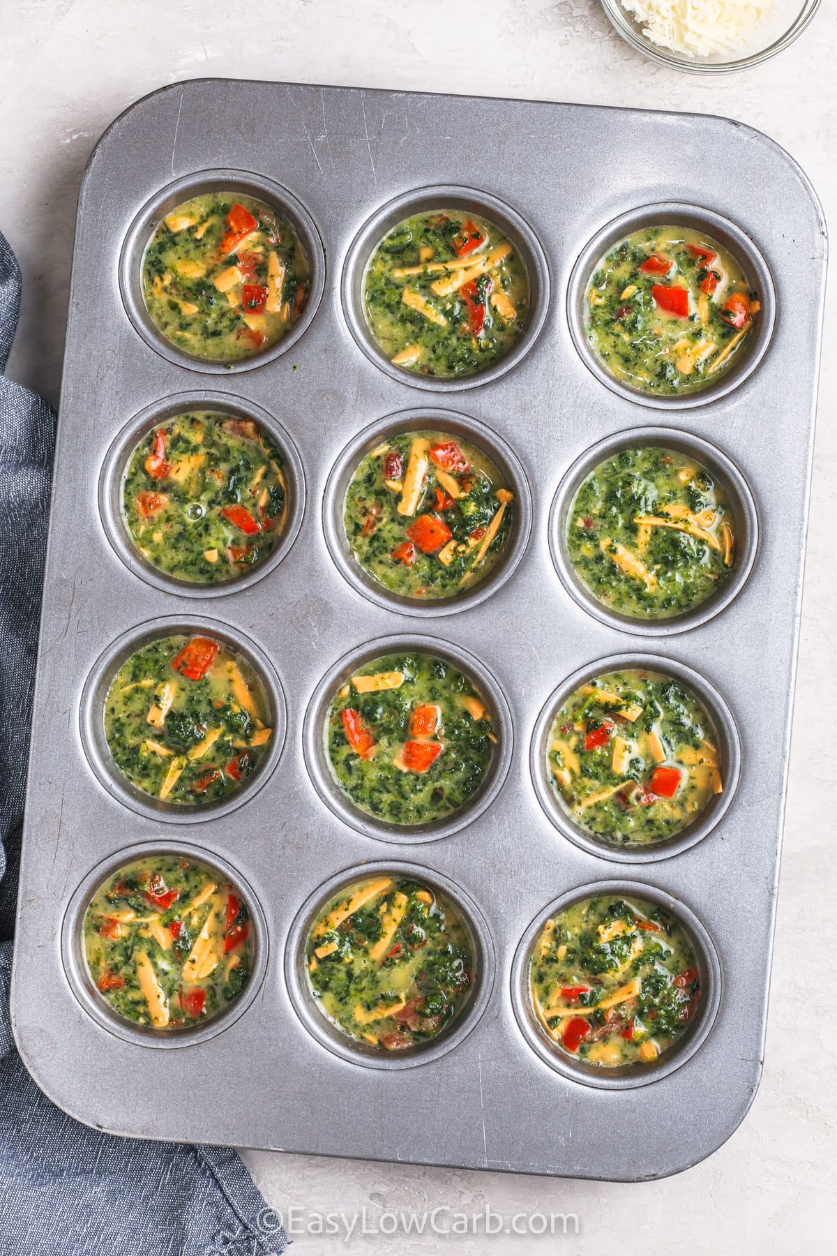 Mini Quiches in the muffin tins before baking
