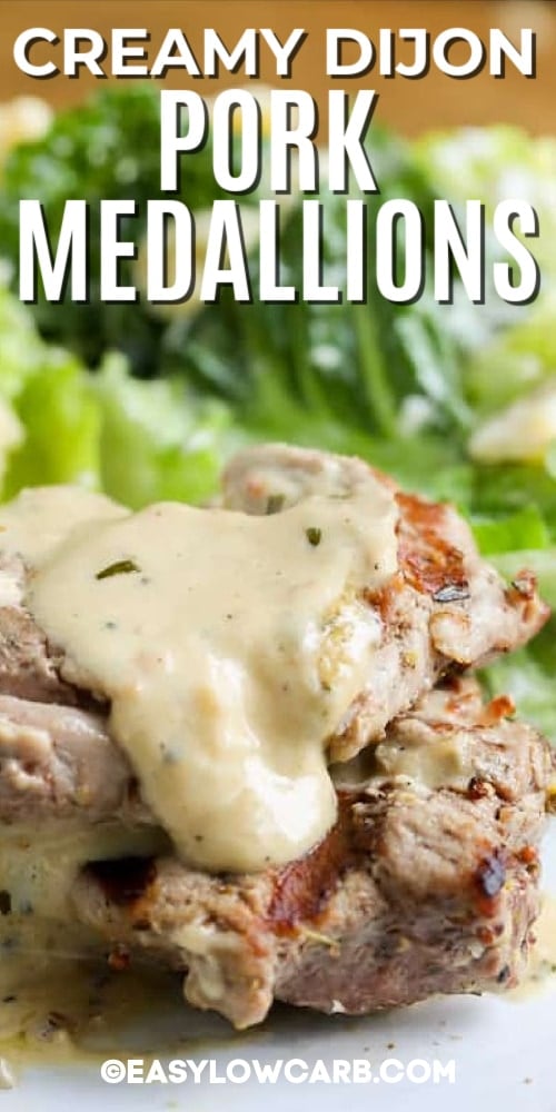 Creamy Dijon Pork Medallions on a plate with a side salad in the background, with a title