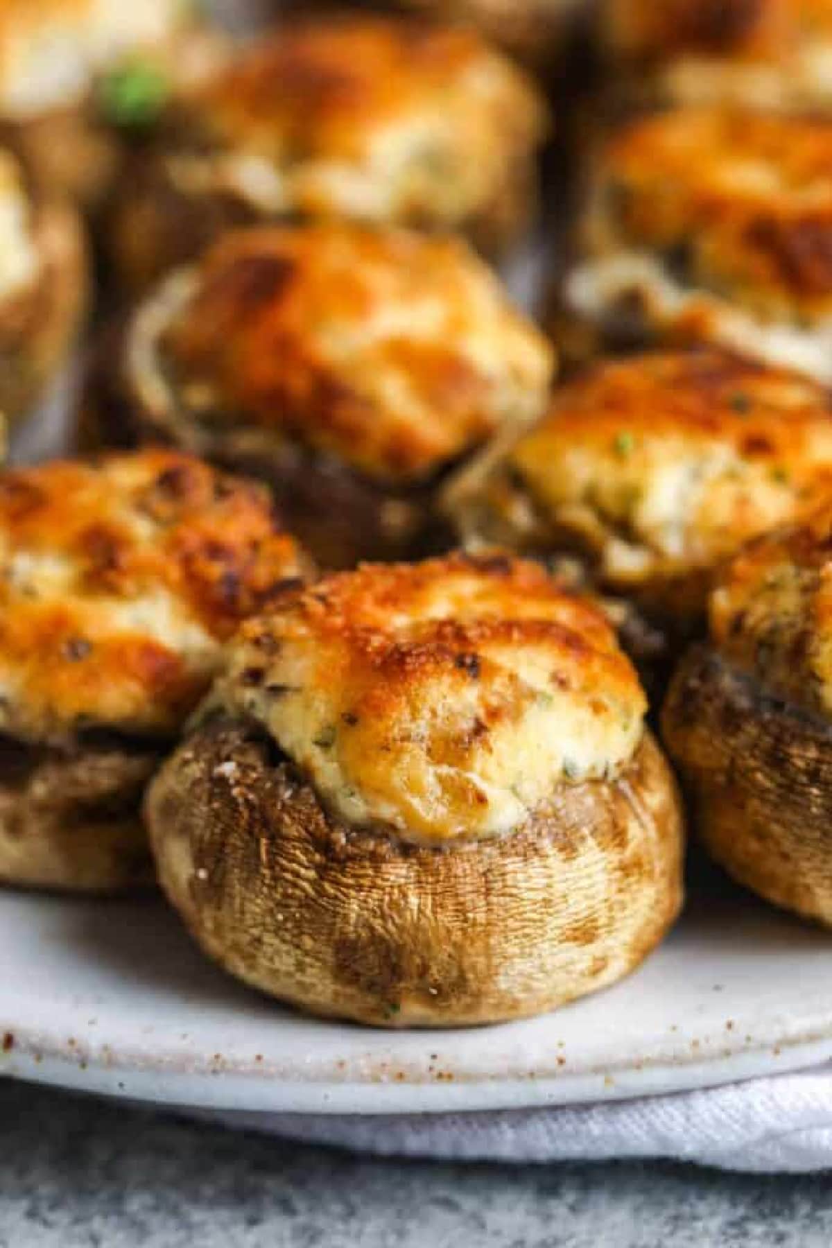 close up of air fryer stuffed mushrooms served on a white plate