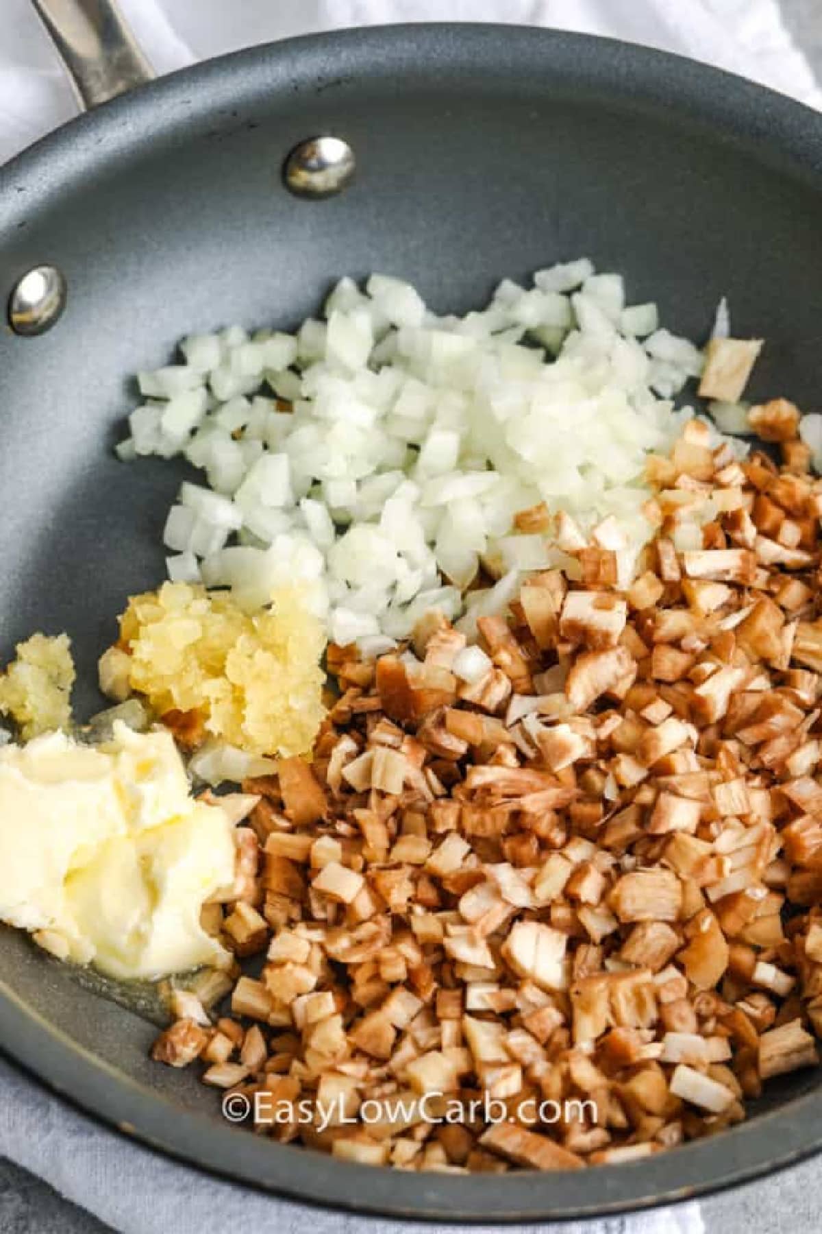 chopped onion, garlic, butter and chopped mushroom stems in a skillet to make air fryer stuffed mushrooms