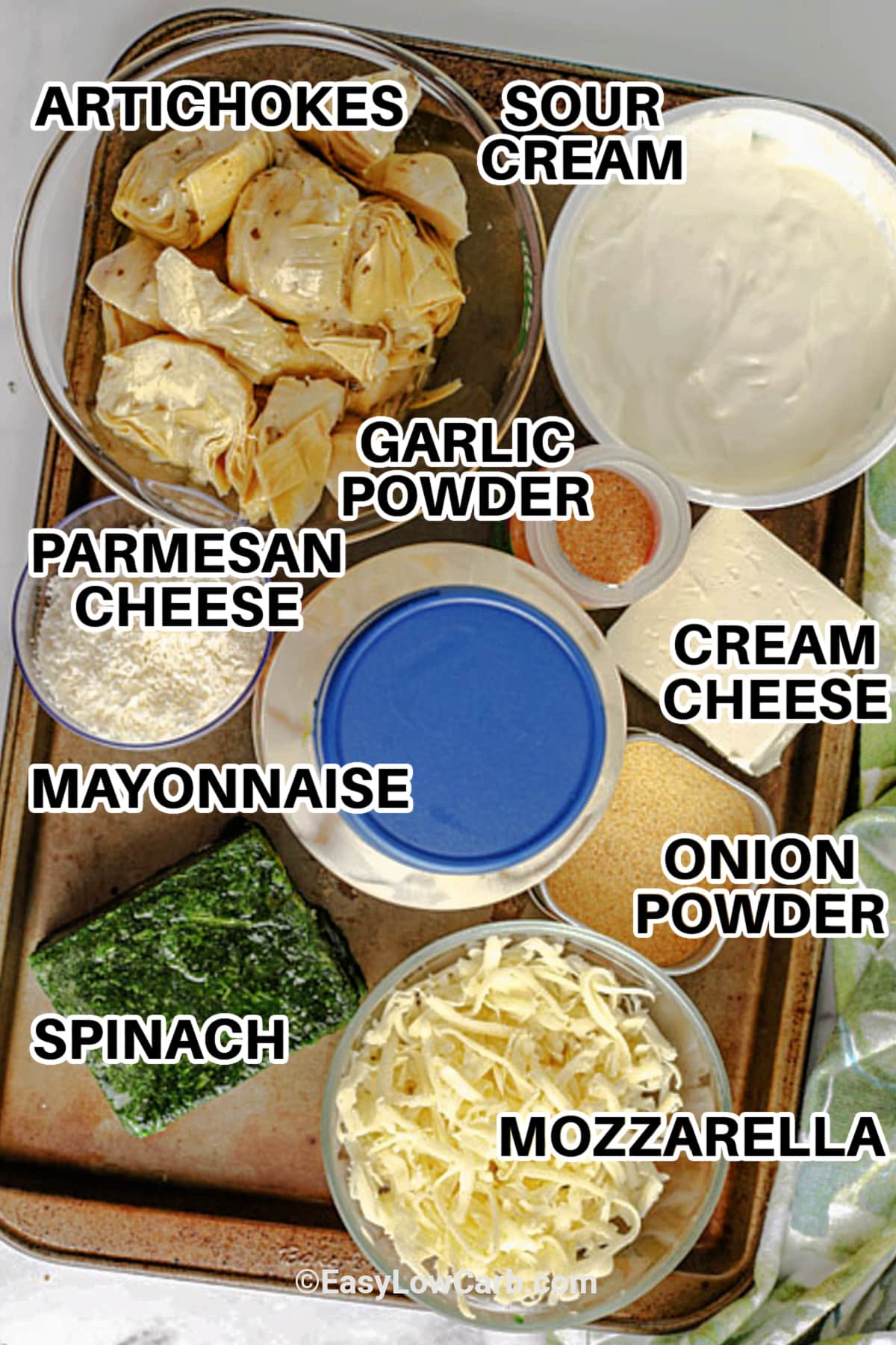 ingredients such as artichokes, sour cream, cream cheese, onion powder, mozzarella, spinach, mayonnaise, parmesan cheese and garlic powder, to make baked artichoke spinach dip with labels.