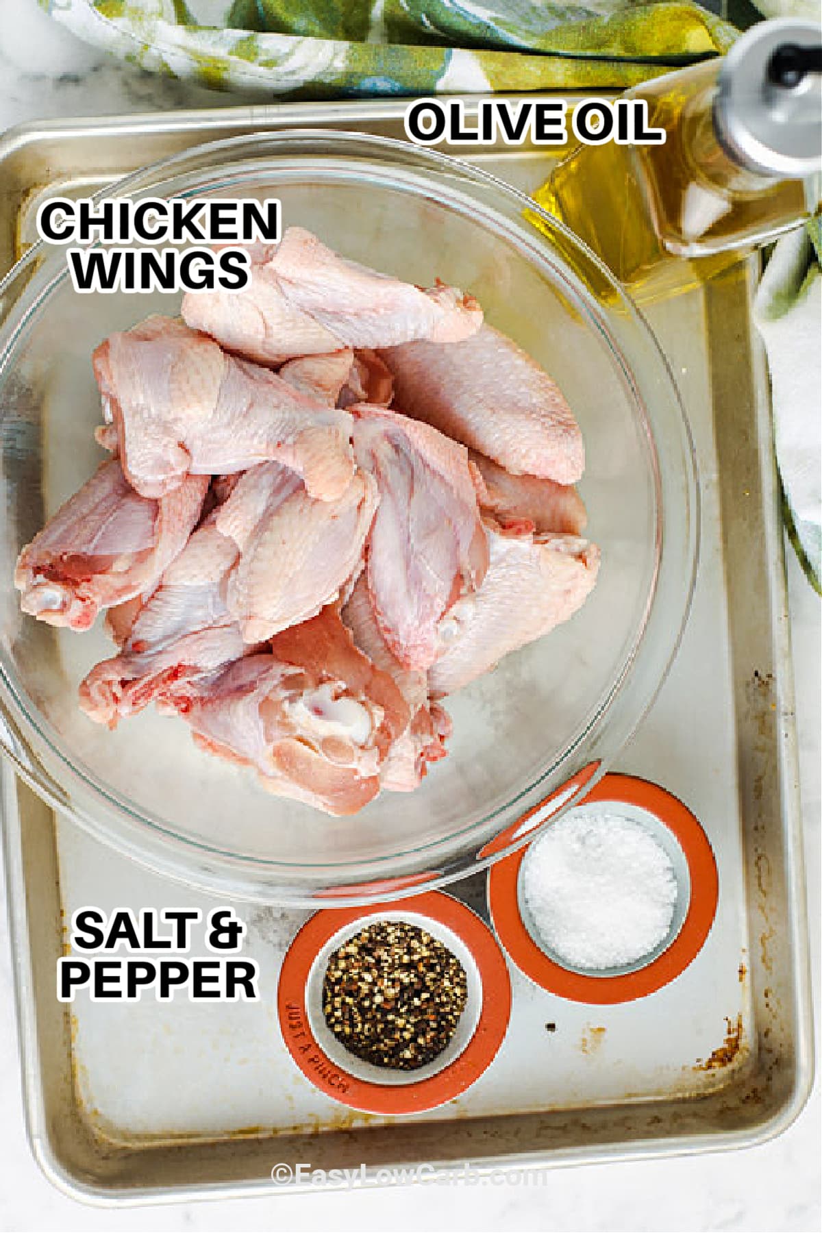 chicken wings, olive oil, salt and pepper on a baking sheet to make air fryer crispy chicken wings.