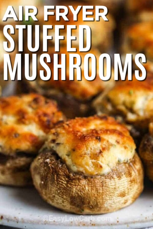 close up of air fryer stuffed mushrooms served on a white plate, with a title