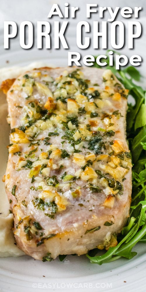 close up of air fryer pork chop resting on a bed of mashed potatoes with arugula on the side with a title