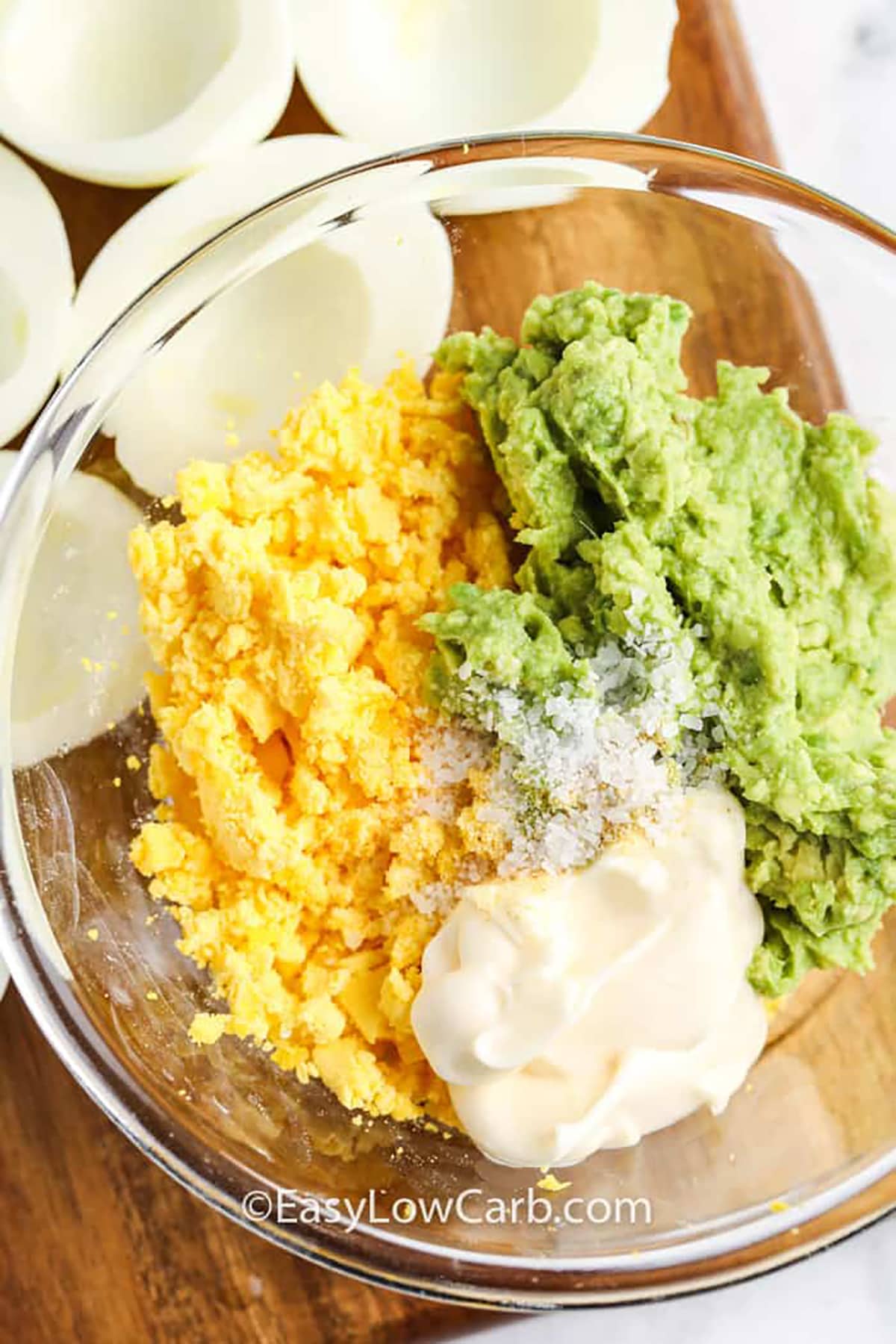 adding ingredients to bowl to make Avocado Deviled Eggs