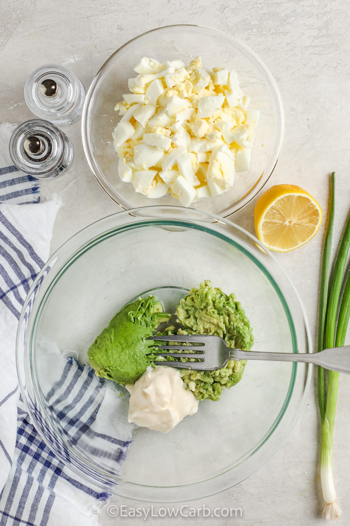 smashing avocado with mayonnaise to make Avocado Egg Salad