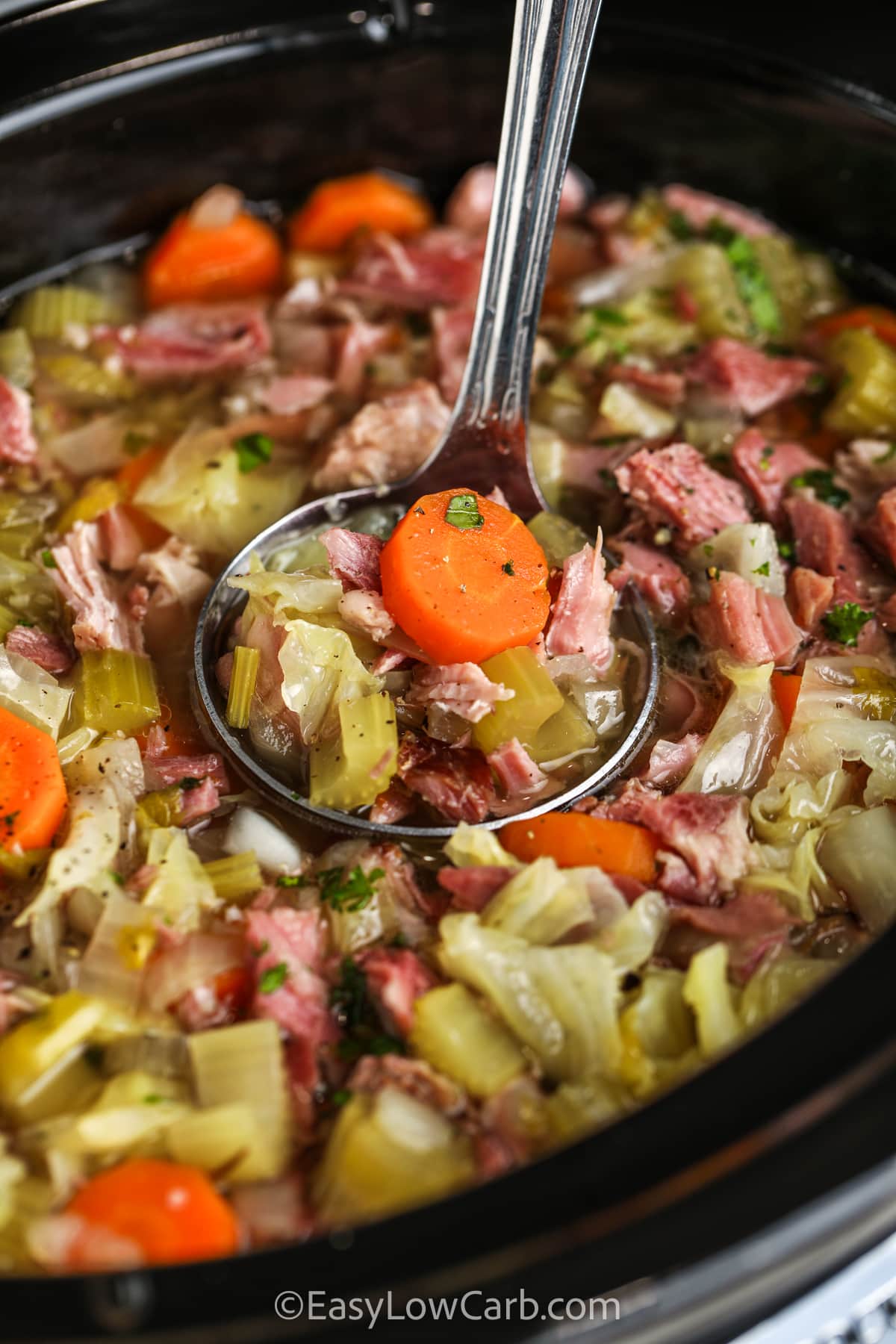 taking a spoonfull of Low Carb Ham Bone Soup out of the pot