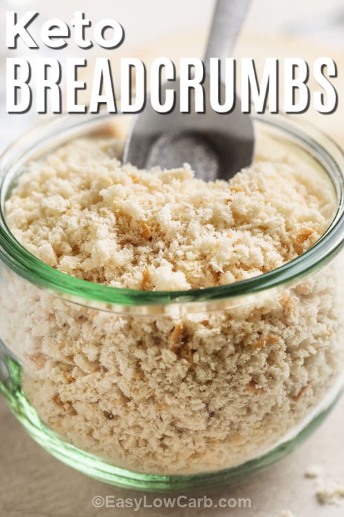 Keto Breadcrumbs in a glass container with a scoop and a title