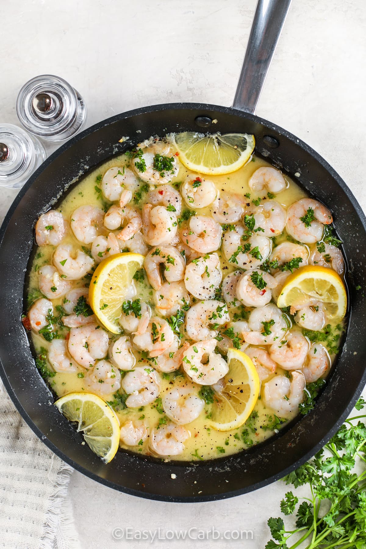 Shrimp Scampi in a pan with lemon slices