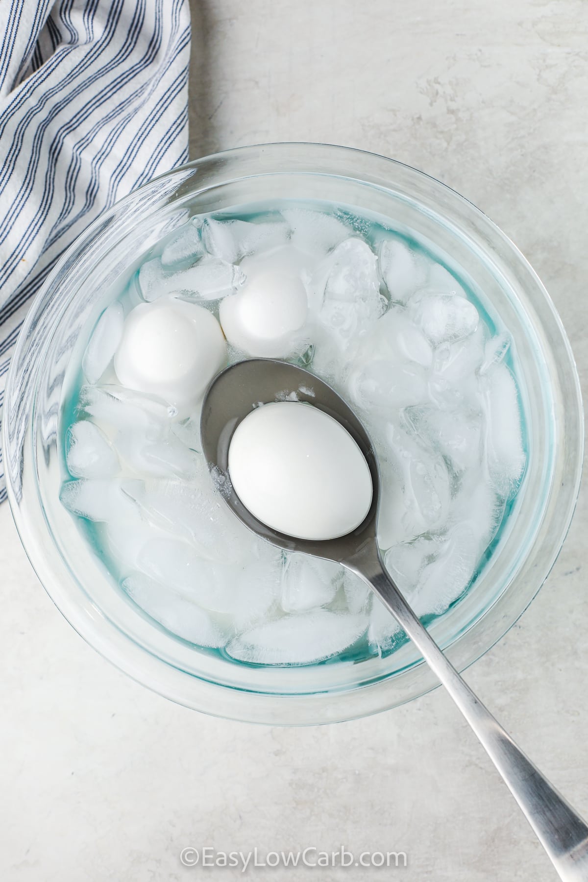 taking an egg out of ice water to make Easy Hard Boiled Eggs