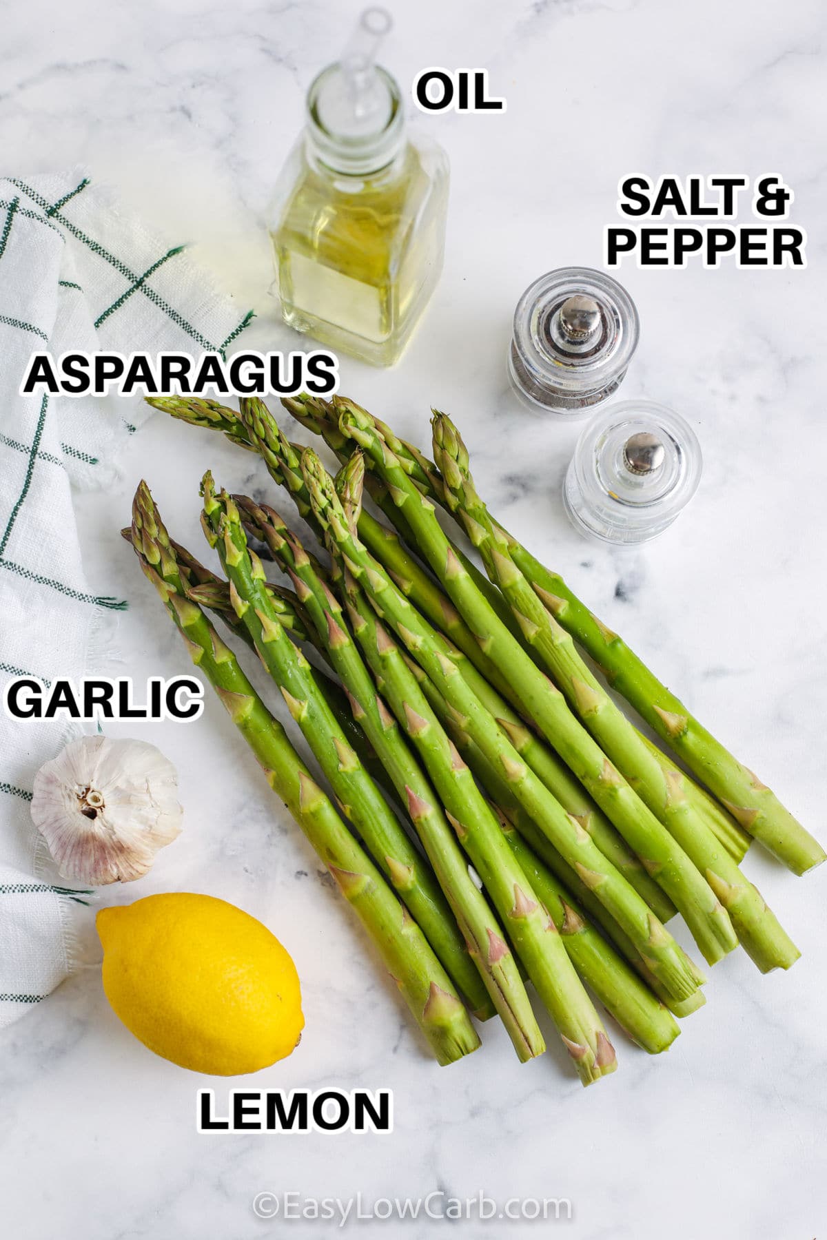 oil, salt and pepper, asparagus, garlic and lemon with labels to make oven roasted asparagus recipe