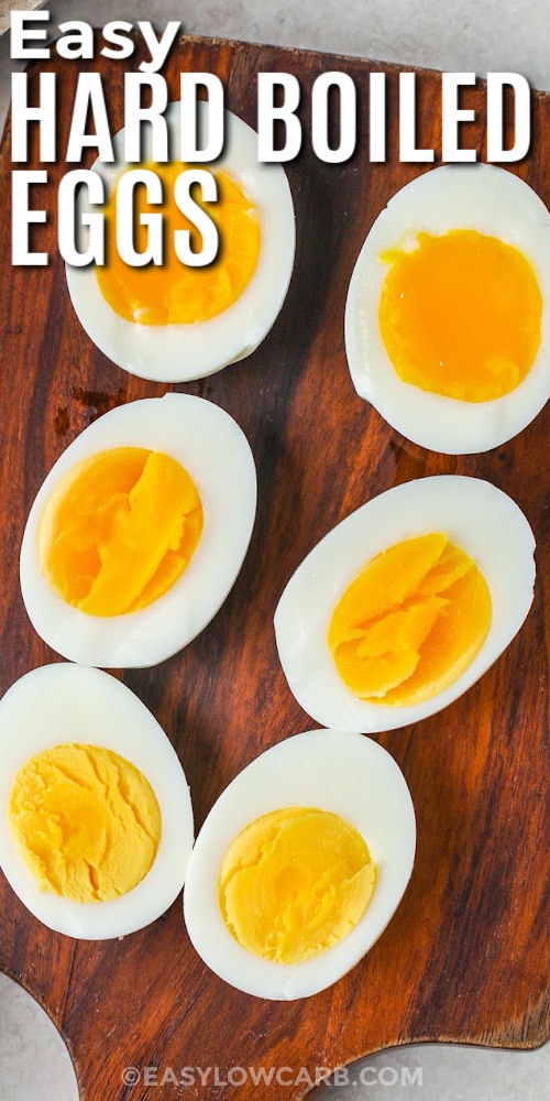 Easy Hard Boiled Eggs on a wooden board with writing