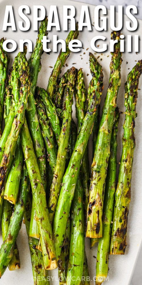 seasoned Grilled Asparagus Recipe on a plate with writing