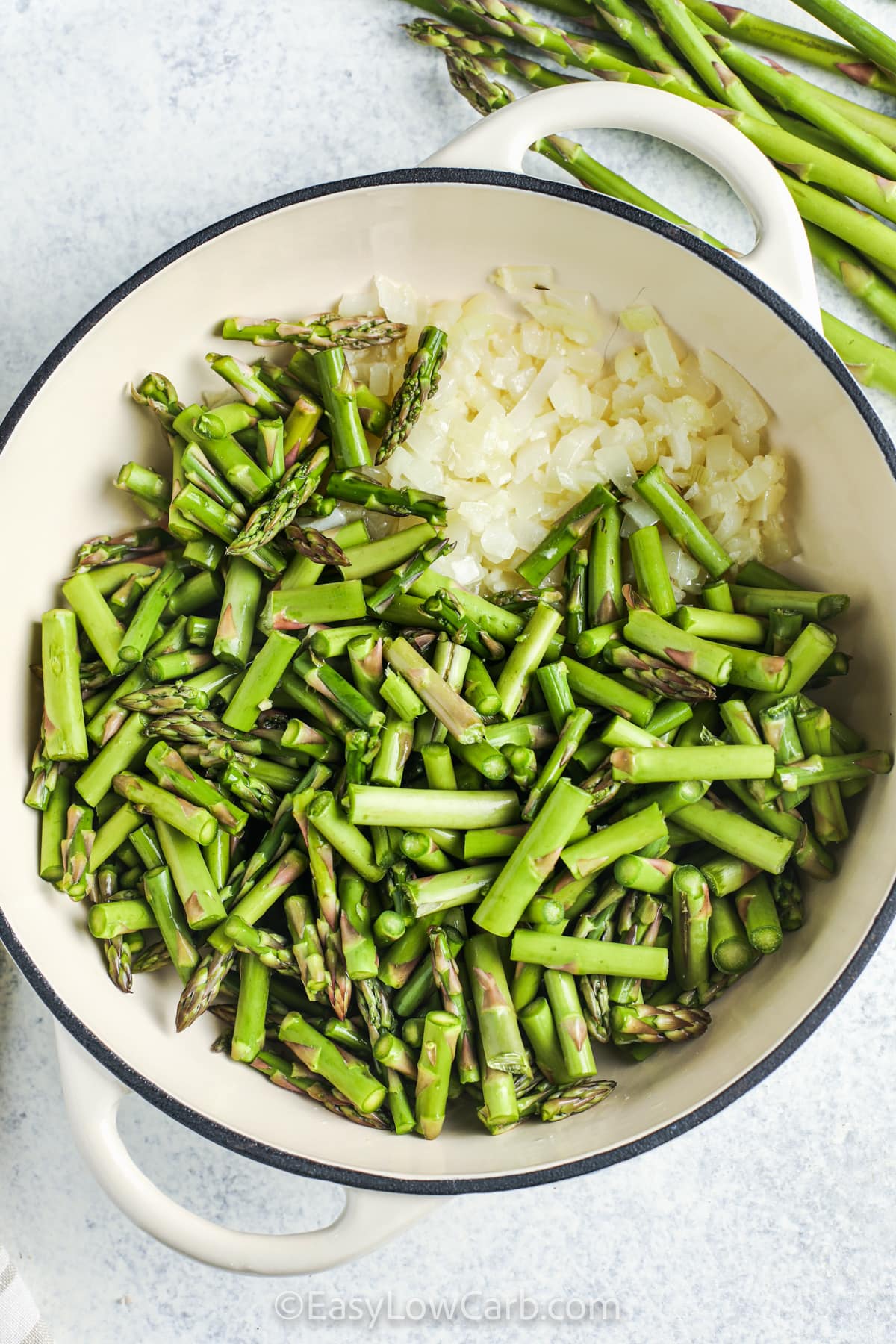 asparagus and onions in a pot to make creamy asparagus soup