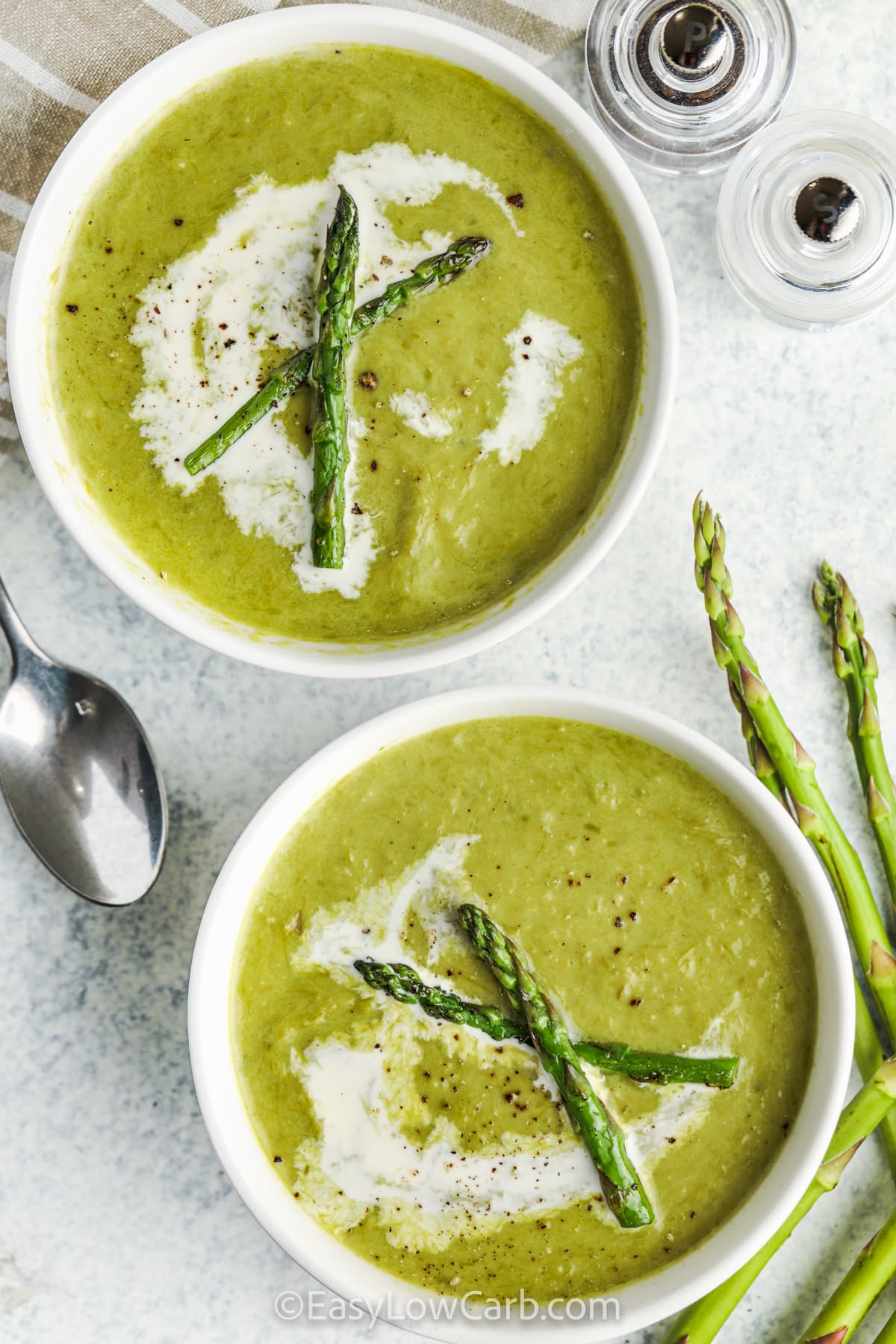 plated Creamy Asparagus Soup with asparagus pieces and cream on top