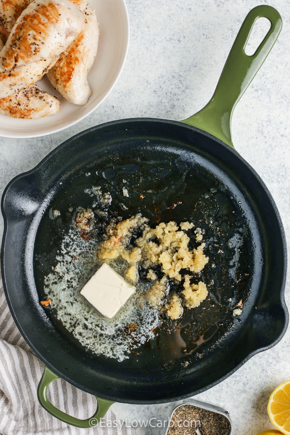 butter and garlic cooking in a pan to make Lemon Garlic Chicken