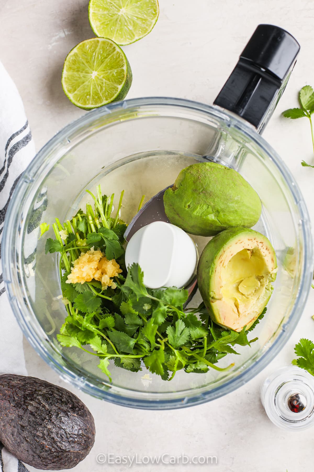 adding ingredients to food processor to make Avocado Lime Dressing