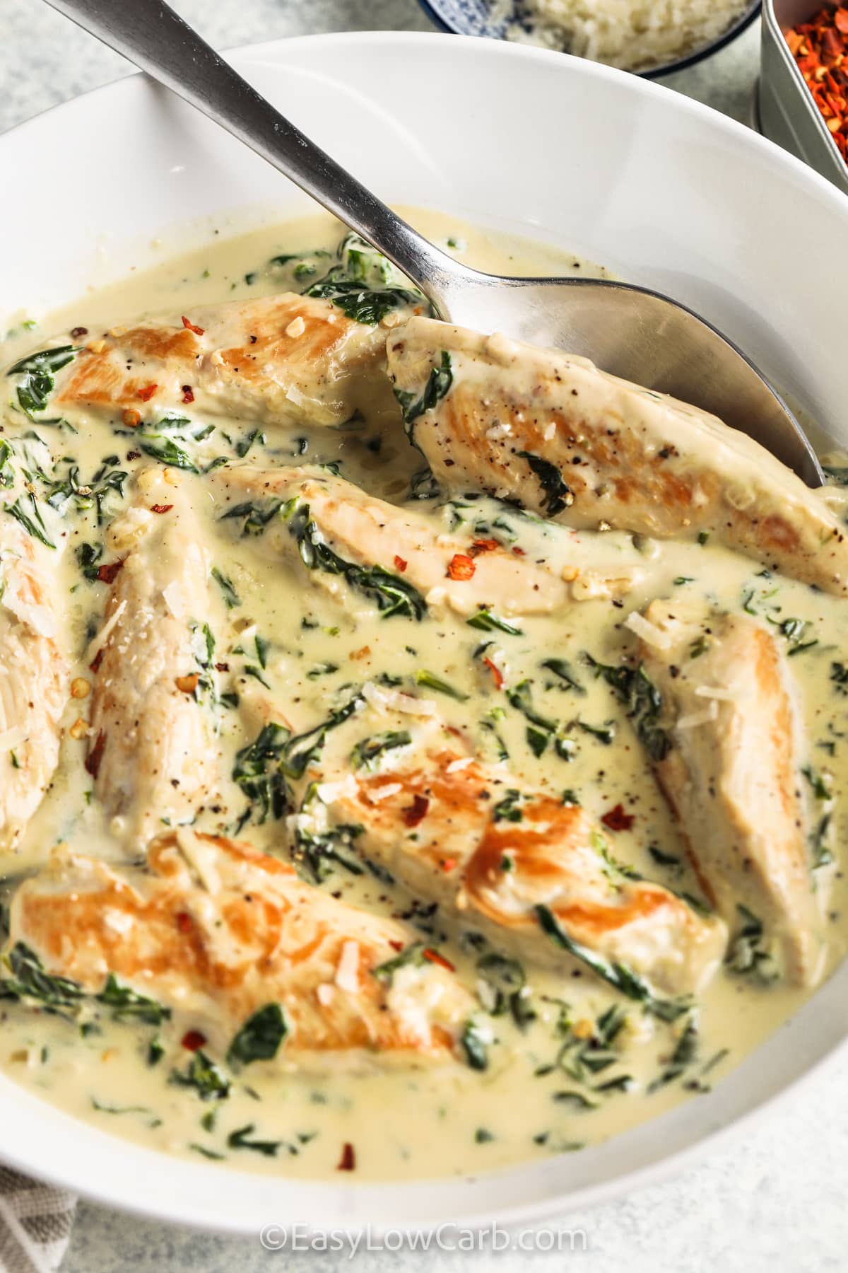 Creamy Spinach Chicken in a bowl with a spoon