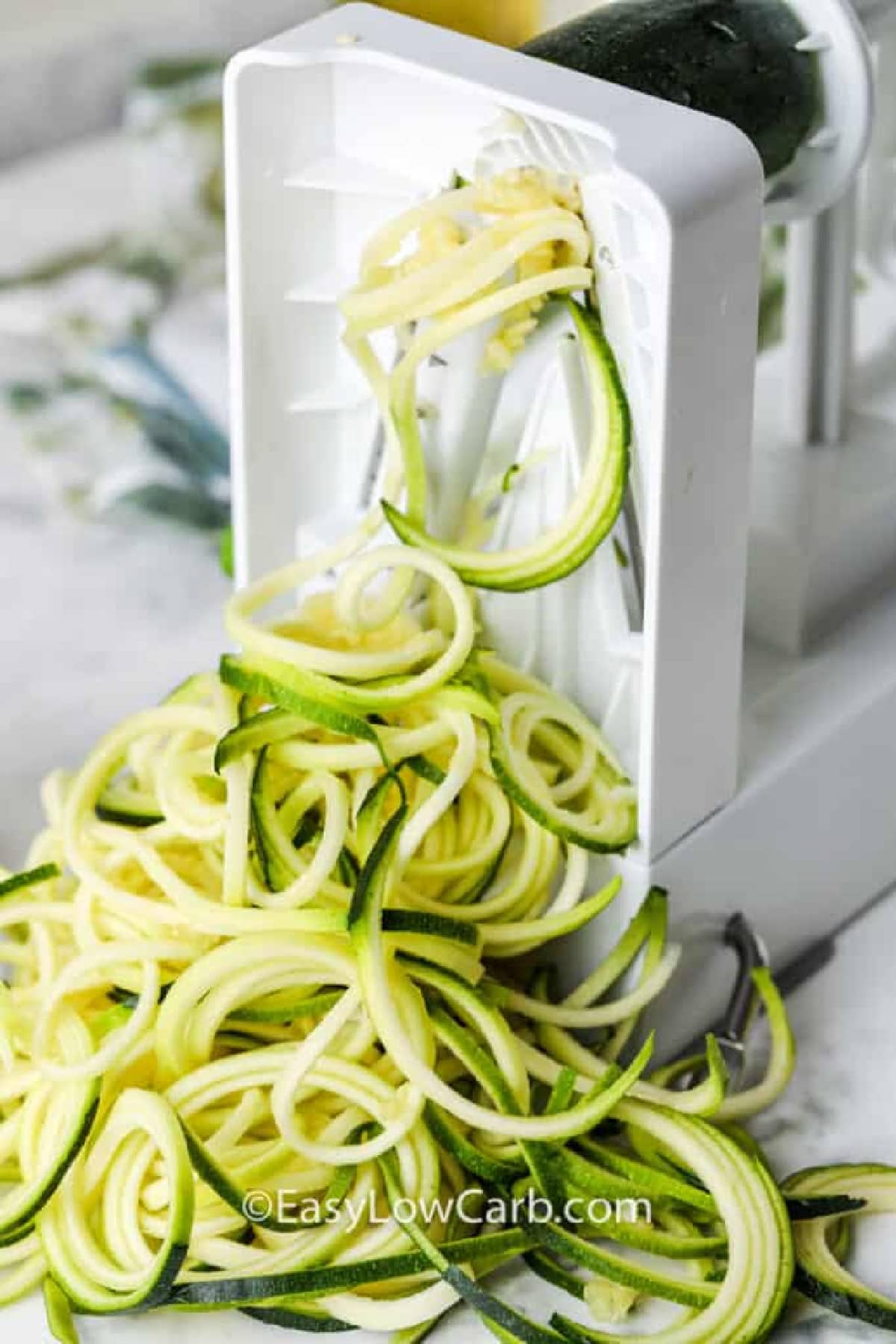 zucchini being spiralized to make zucchini pasta salad