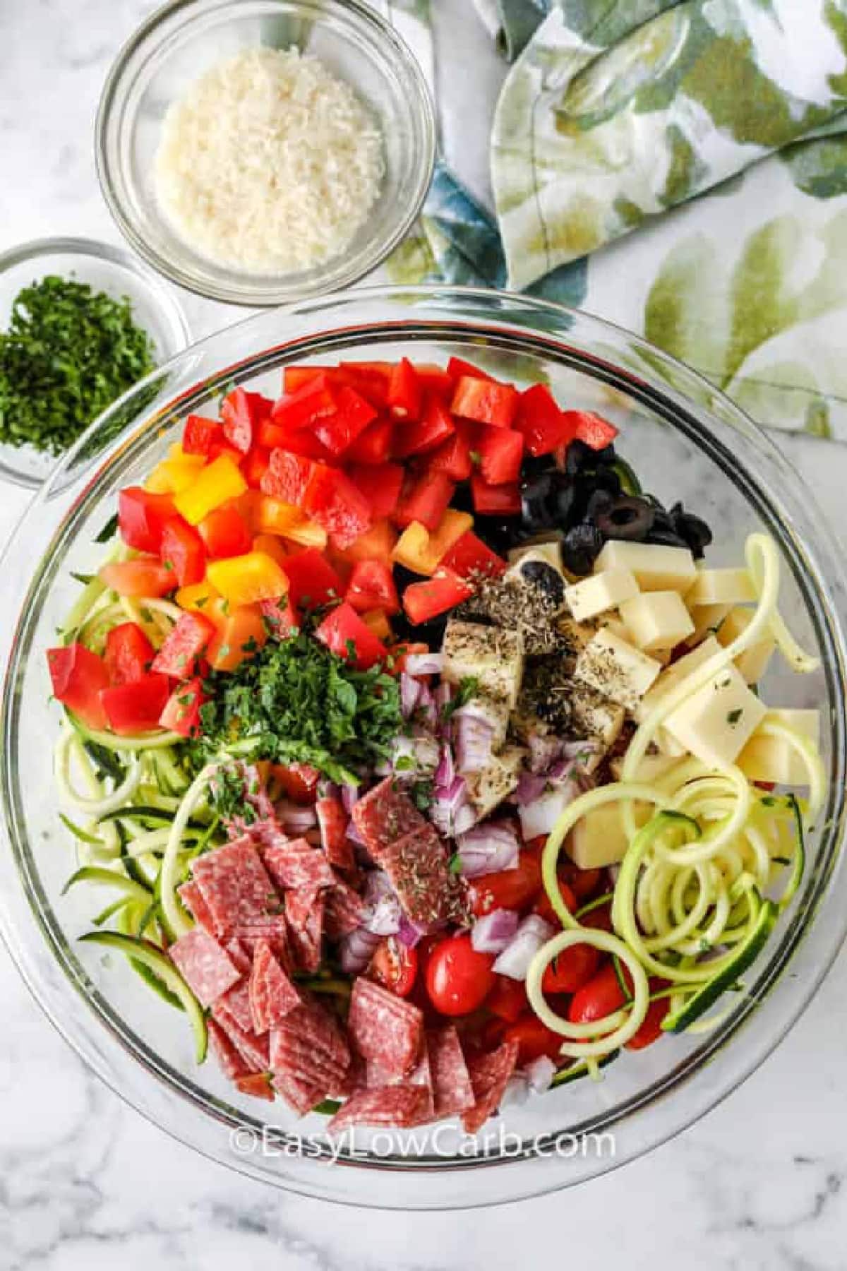 Zucchini Pasta Salad ingredients in a clear mixing bowl