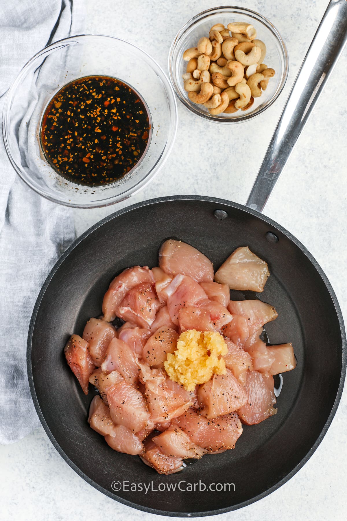 adding seasonings to cooking chicken to make Cashew Chicken Recipe