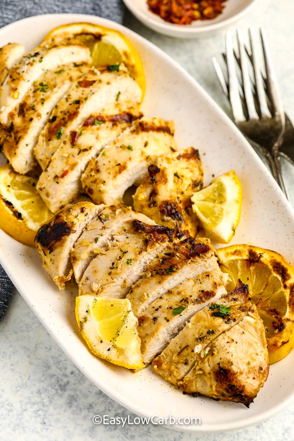 greek yogurt chicken and lemon slices on a plate