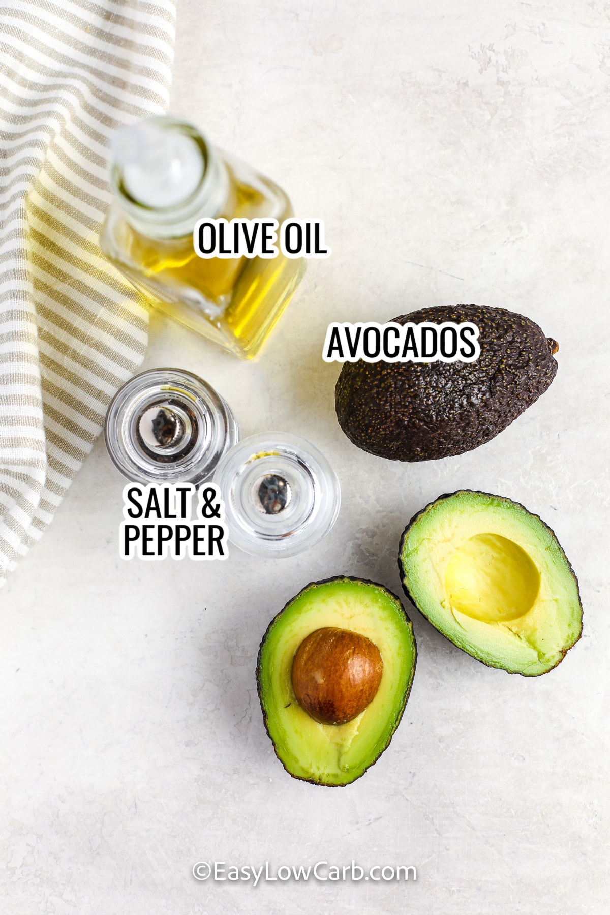 ingredients assembled to make grilled avocado, including avocado, salt and pepper, and olive oil