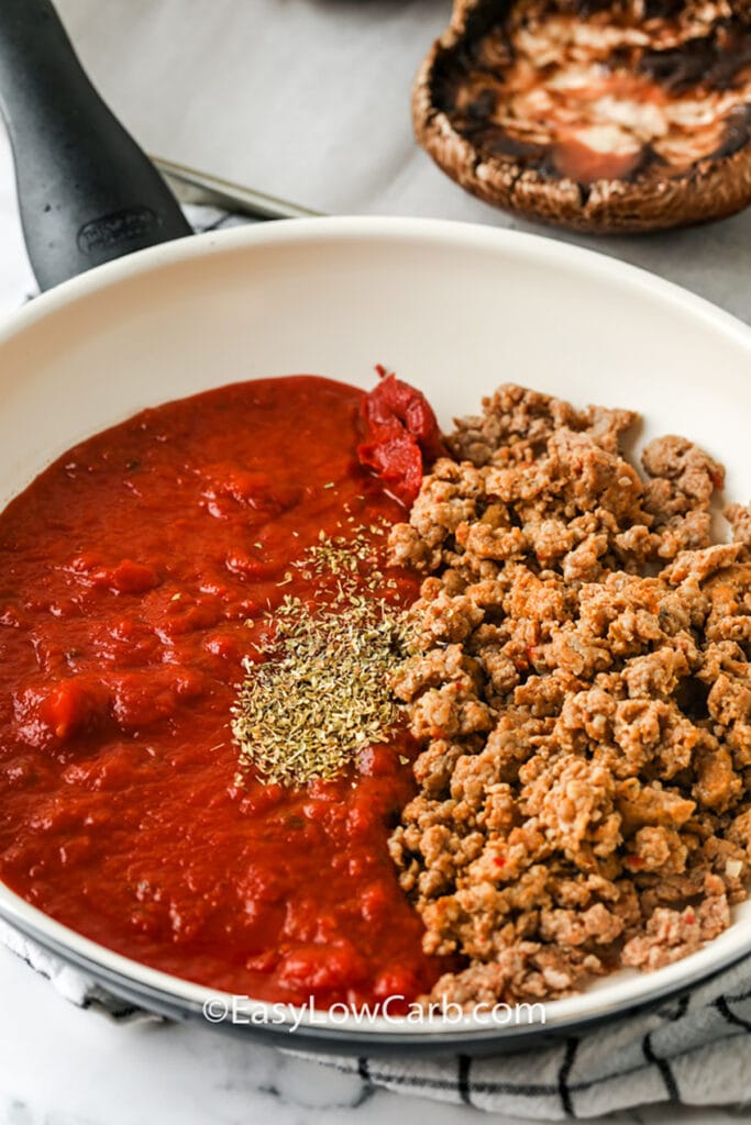 adding beef with tomato sauce and sseasonings to make filling for Portobello Mushroom Pizza