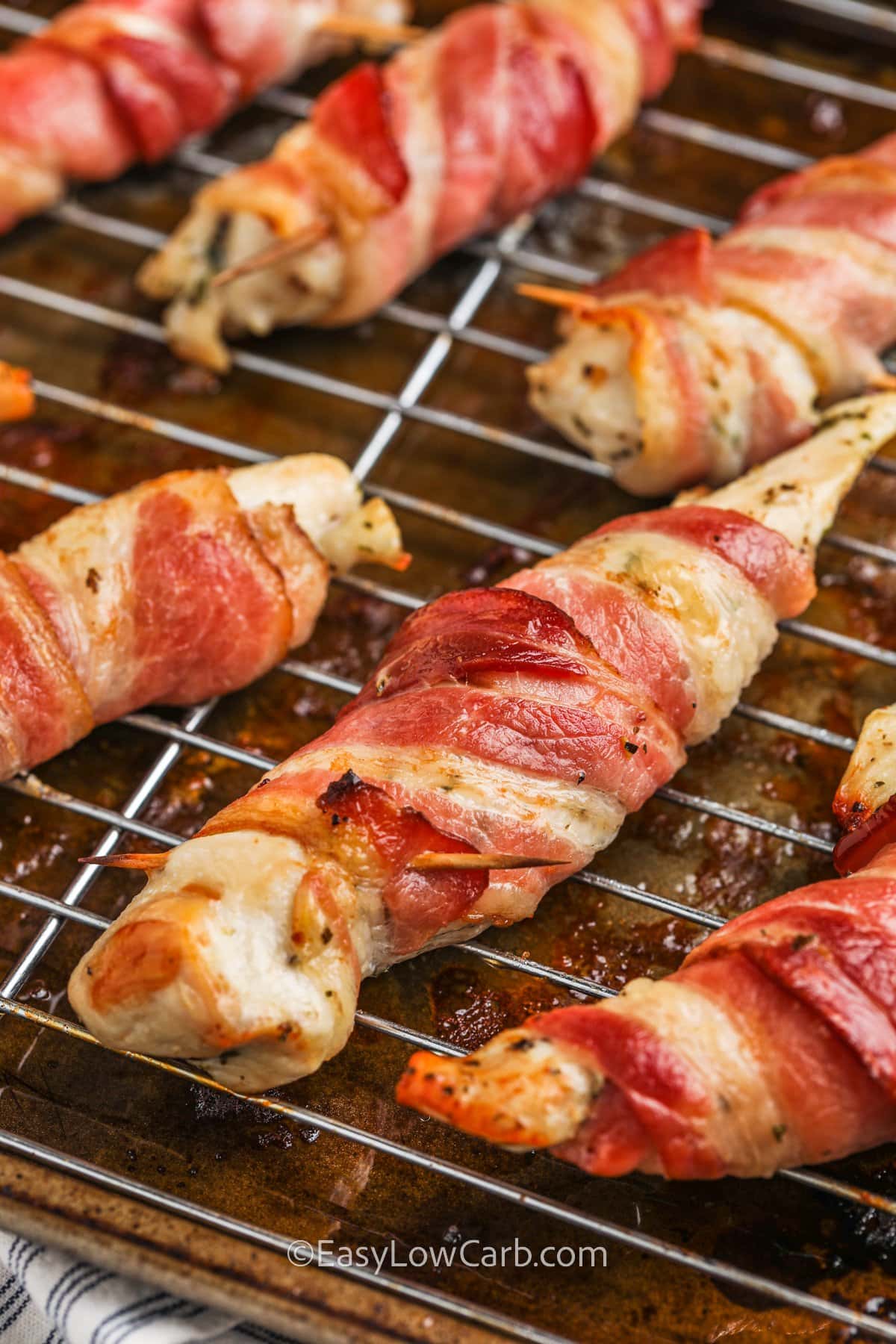 Bacon wrapped chicken cooked on a baking tray