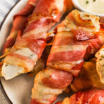 Bacon Wrapped Chicken on a plate with dip