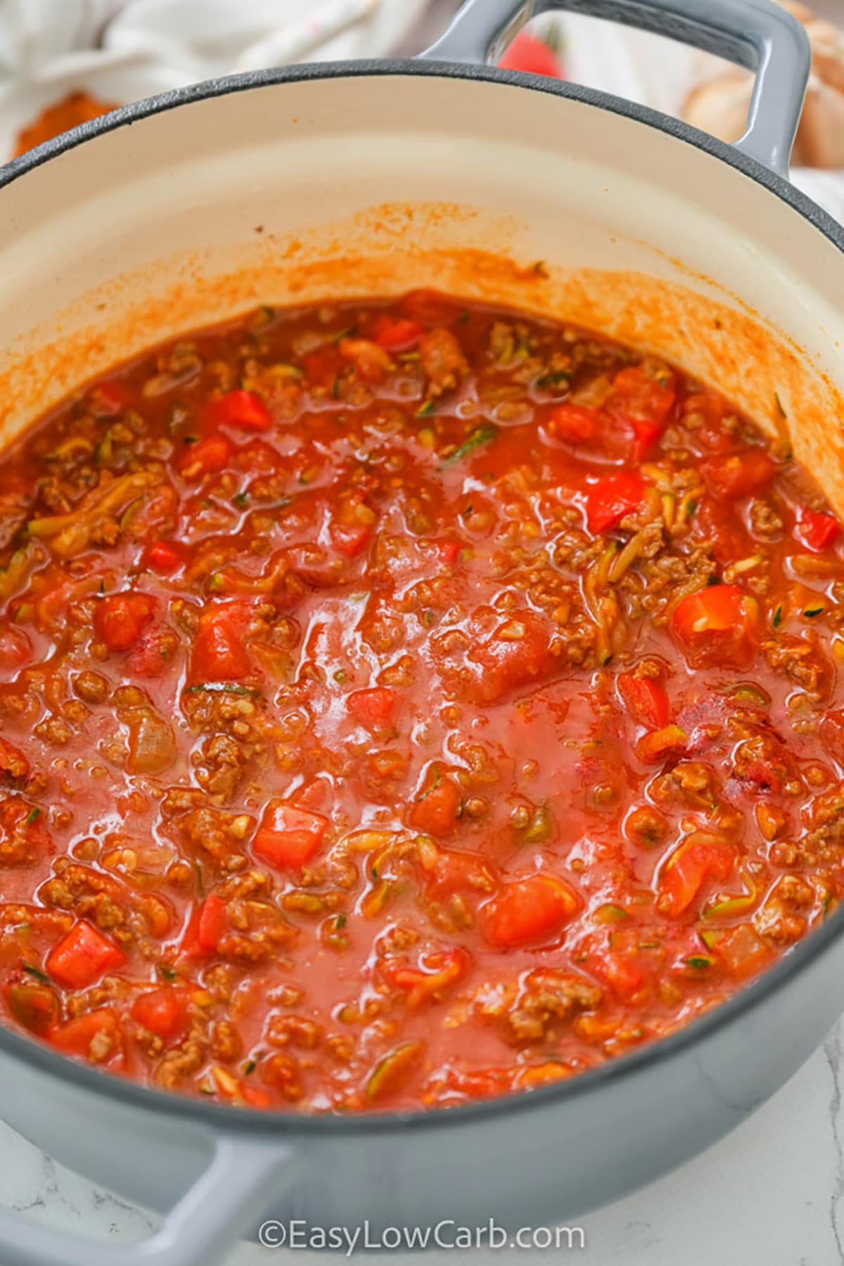 adding tomato sauce to Keto Chili Recipe