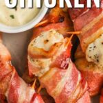 Bacon wrapped chicken on a serving plate with text