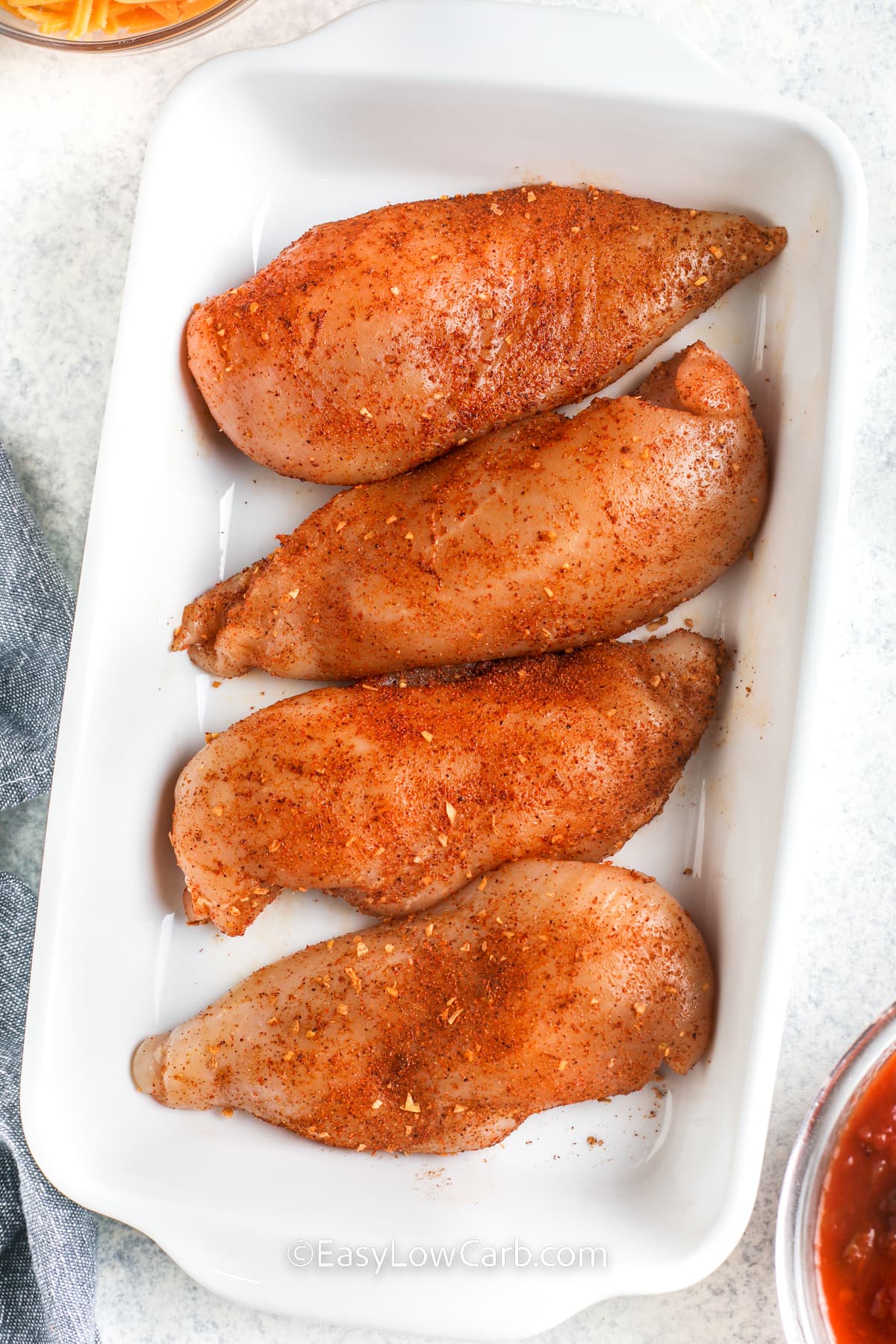 adding seasonings to chicken to make Salsa Chicken Recipe