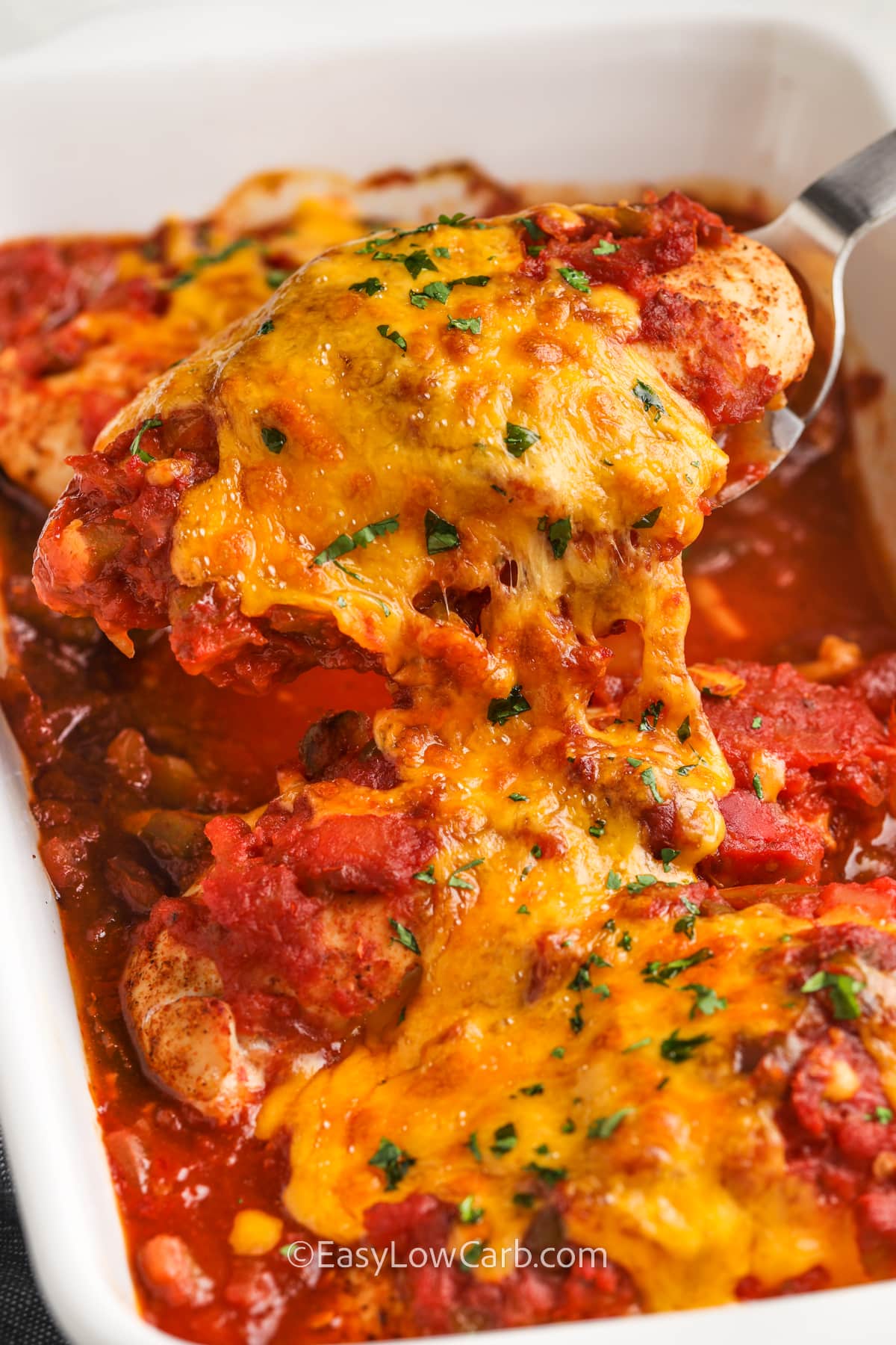 taking a piece of Salsa Chicken Recipe out of the casserole dish