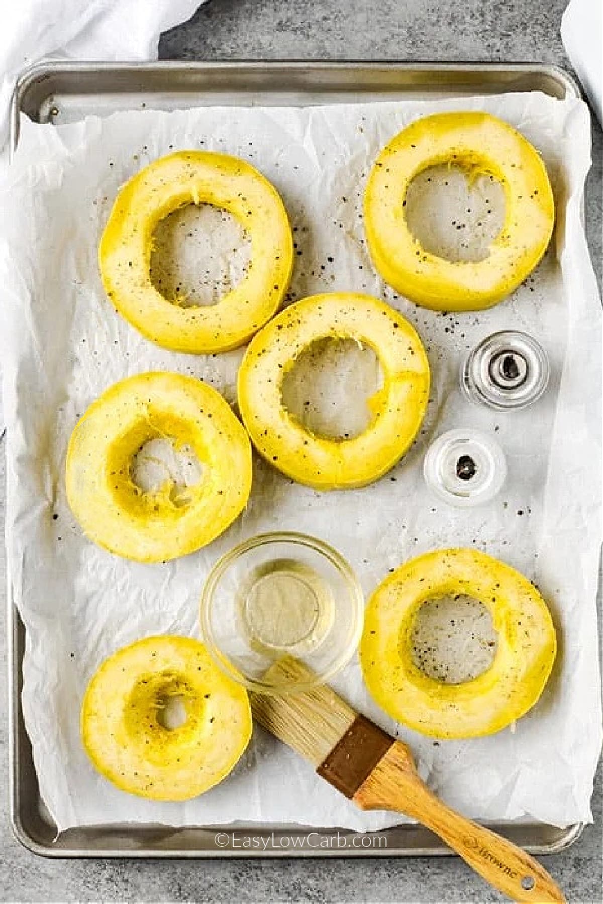 Cut rings of spaghetti squash on a baking tray, with oil.